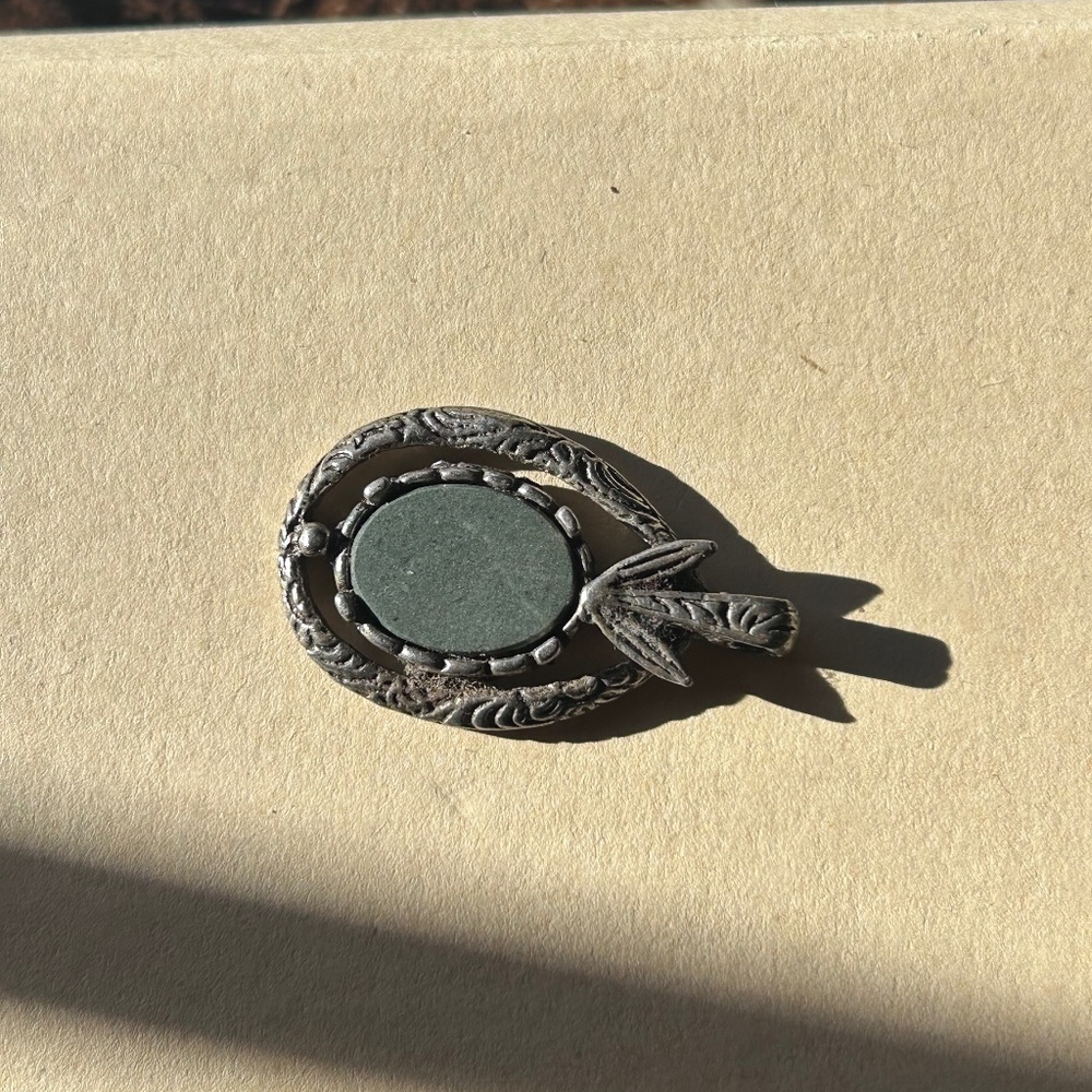 a vintage Miracle Celtic pendant or brooch with a central stone and silver-tone